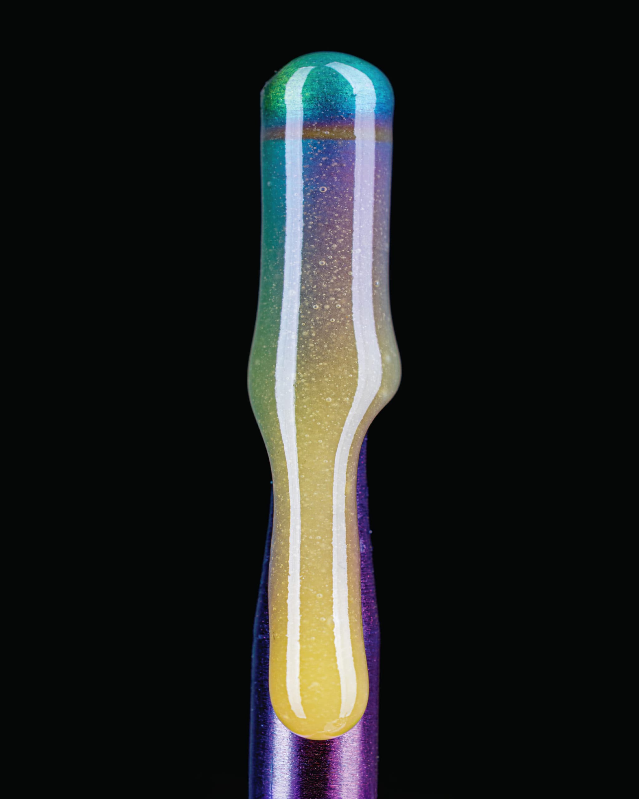 Glittering cannabis pre-roll with rainbow gradient from yellow to teal and purple